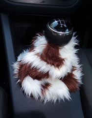 Handmade brown and cream cow print faux fur gear stick gaiter cover showing the fluffy texture and elasticated base.